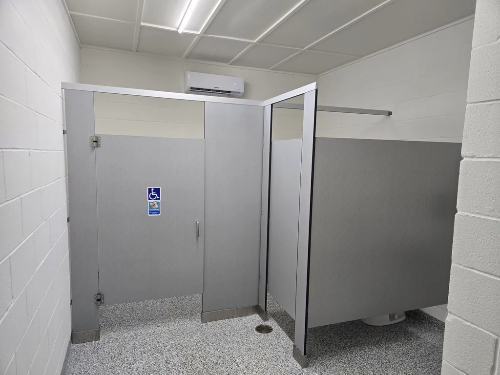 Gray flake flooring in a finished commercial restroom