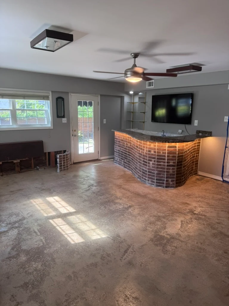 Natural grind-and-seal concrete in a brick-accented interior